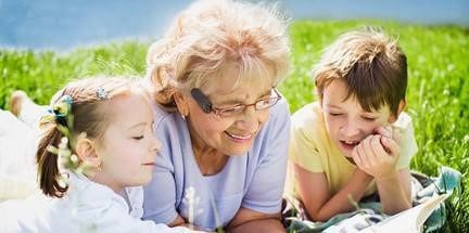 Grandma Reading a Book With Grandchildren