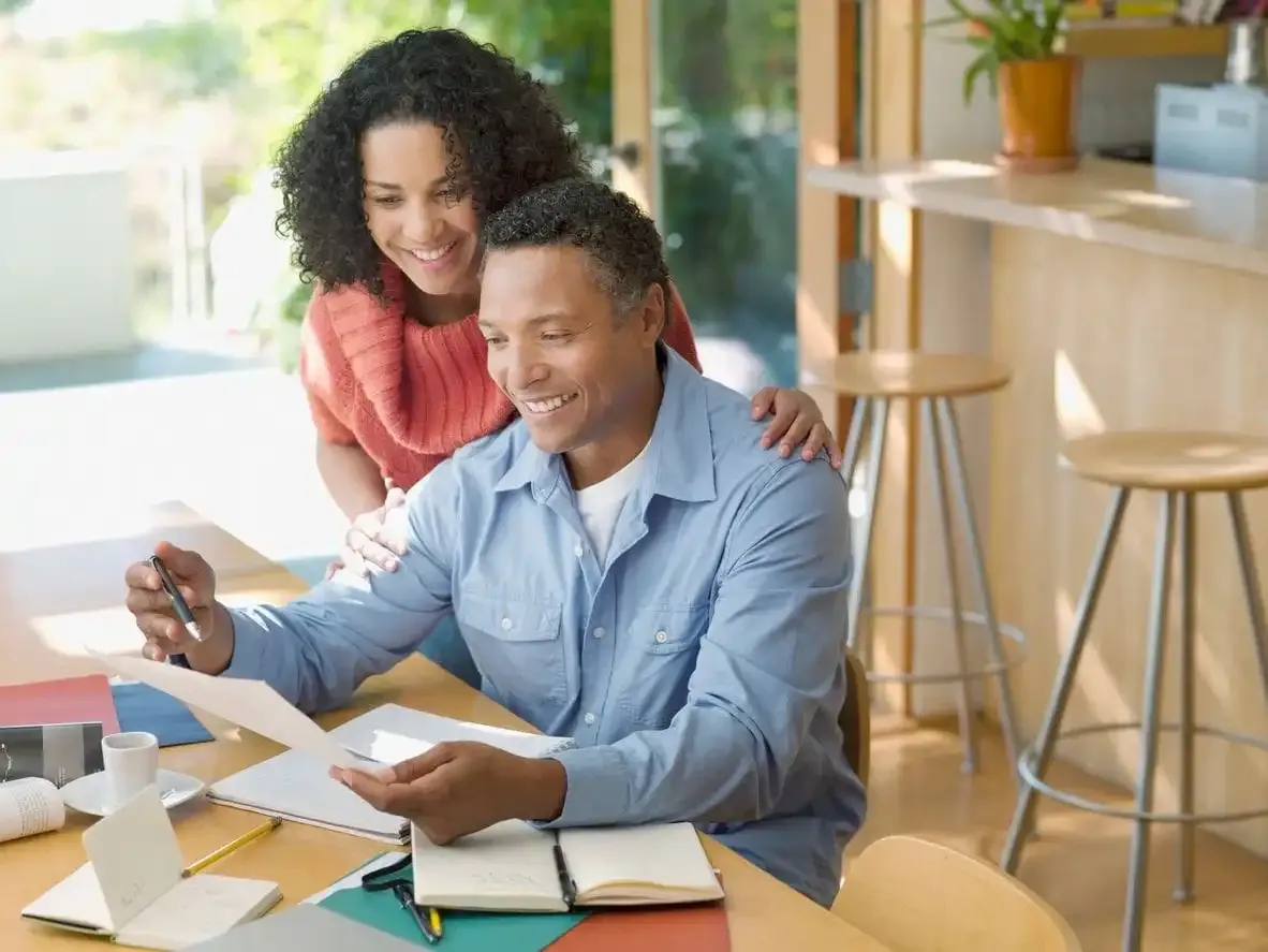 Couple reviewing documents at home