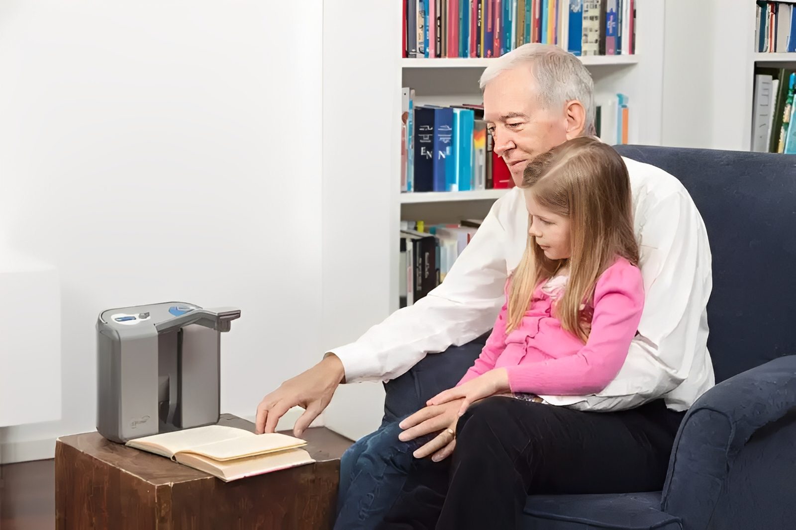 Man and girl reading with a device.