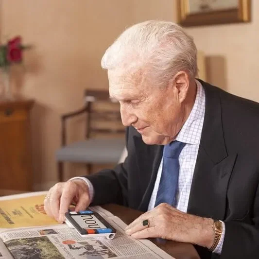 Elderly man reading a newspaper