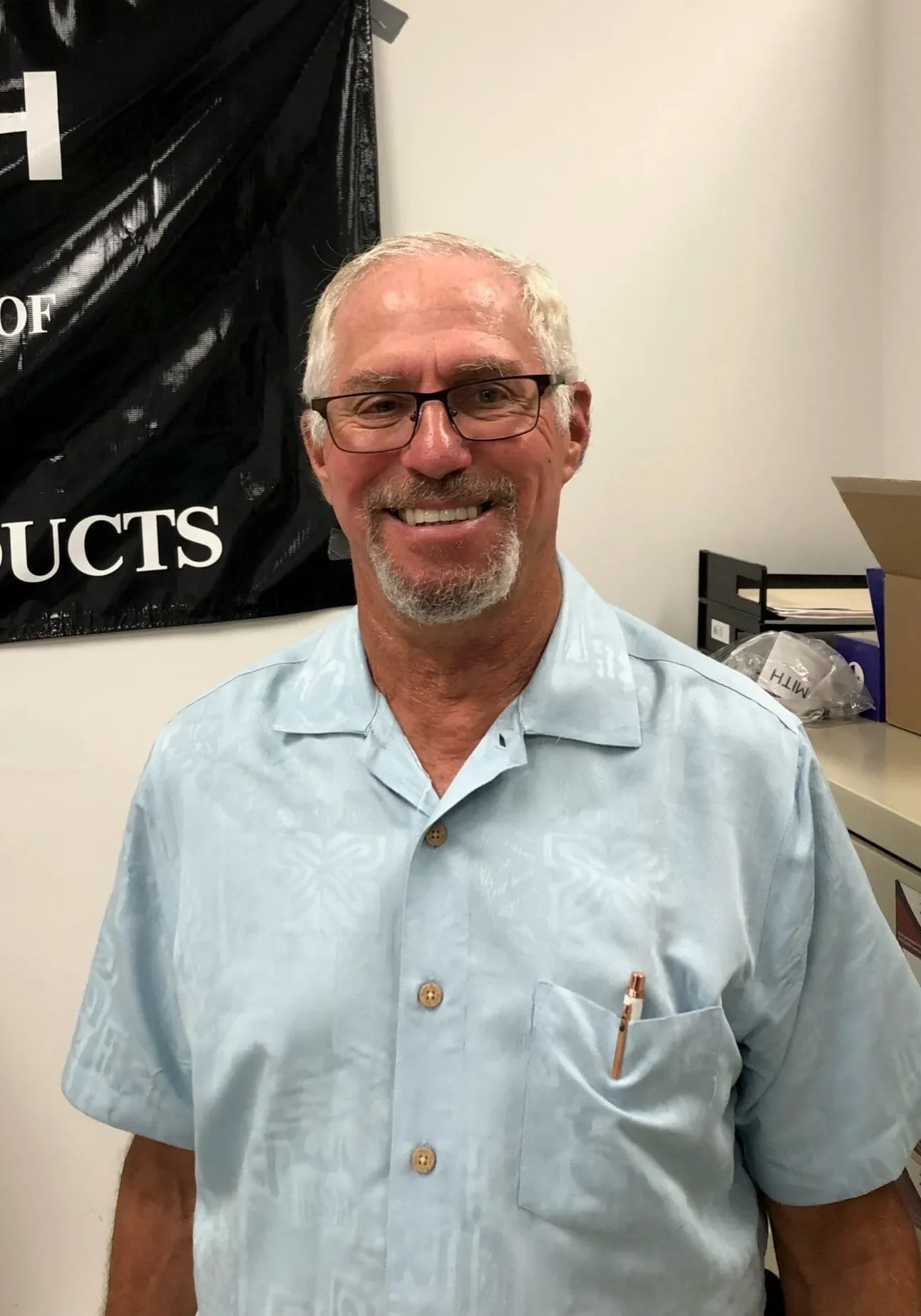 Man smiling in an office setting